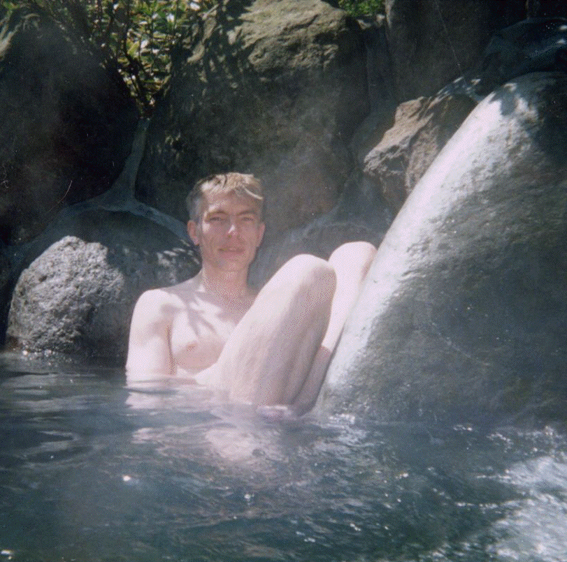 A thumbnail image of the author sitting nude in a hotspring amongst the rocks at Tenzan