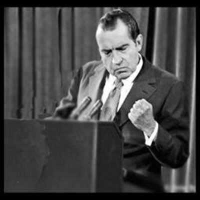 Image of Nixon at a podium displaying a fist.